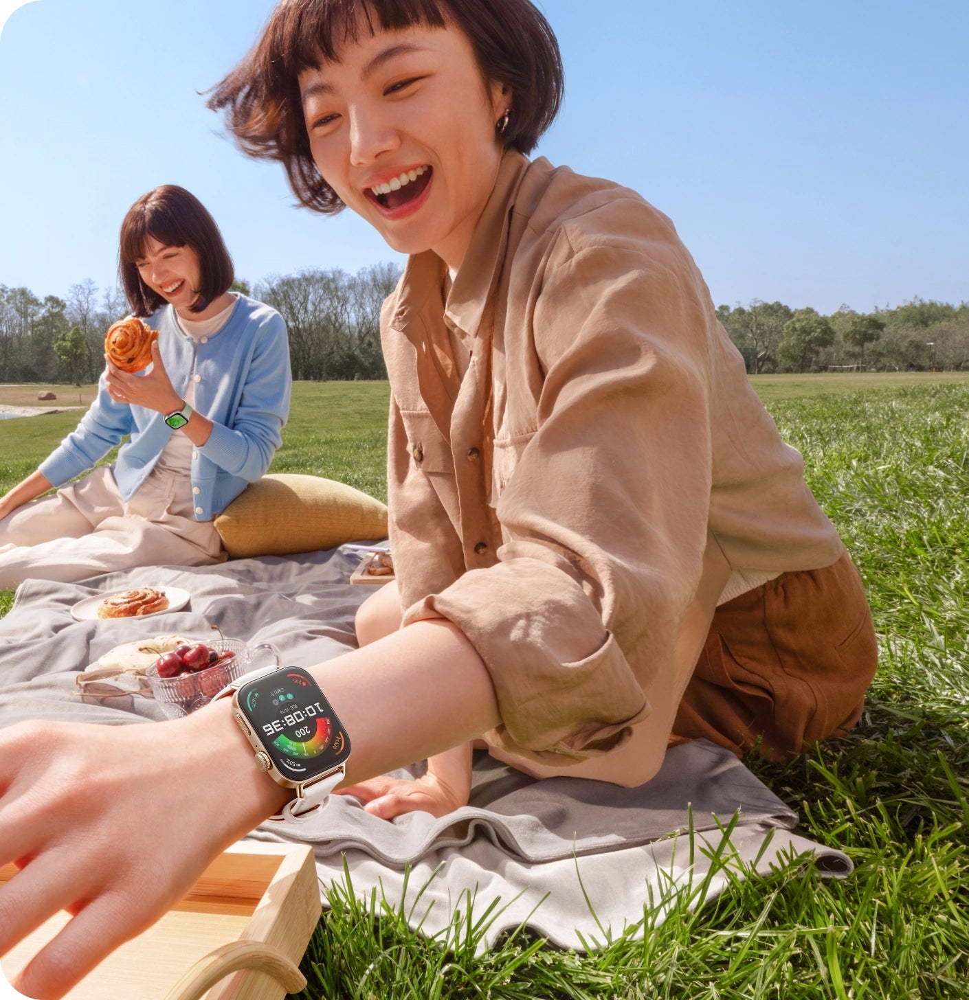 Huawei Watch Fit 3 smartwatch worn by women outdoors during picnic, lifestyle photo.